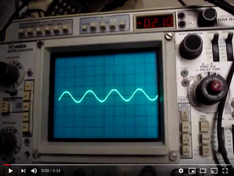 A picture of an oscilloscope with the screen showing a wave.