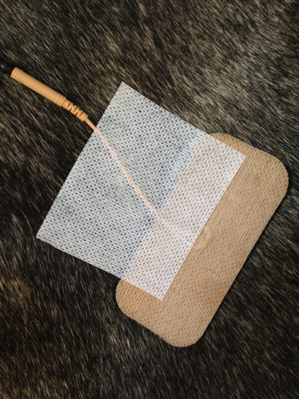 A wooden board with a piece of paper on it.